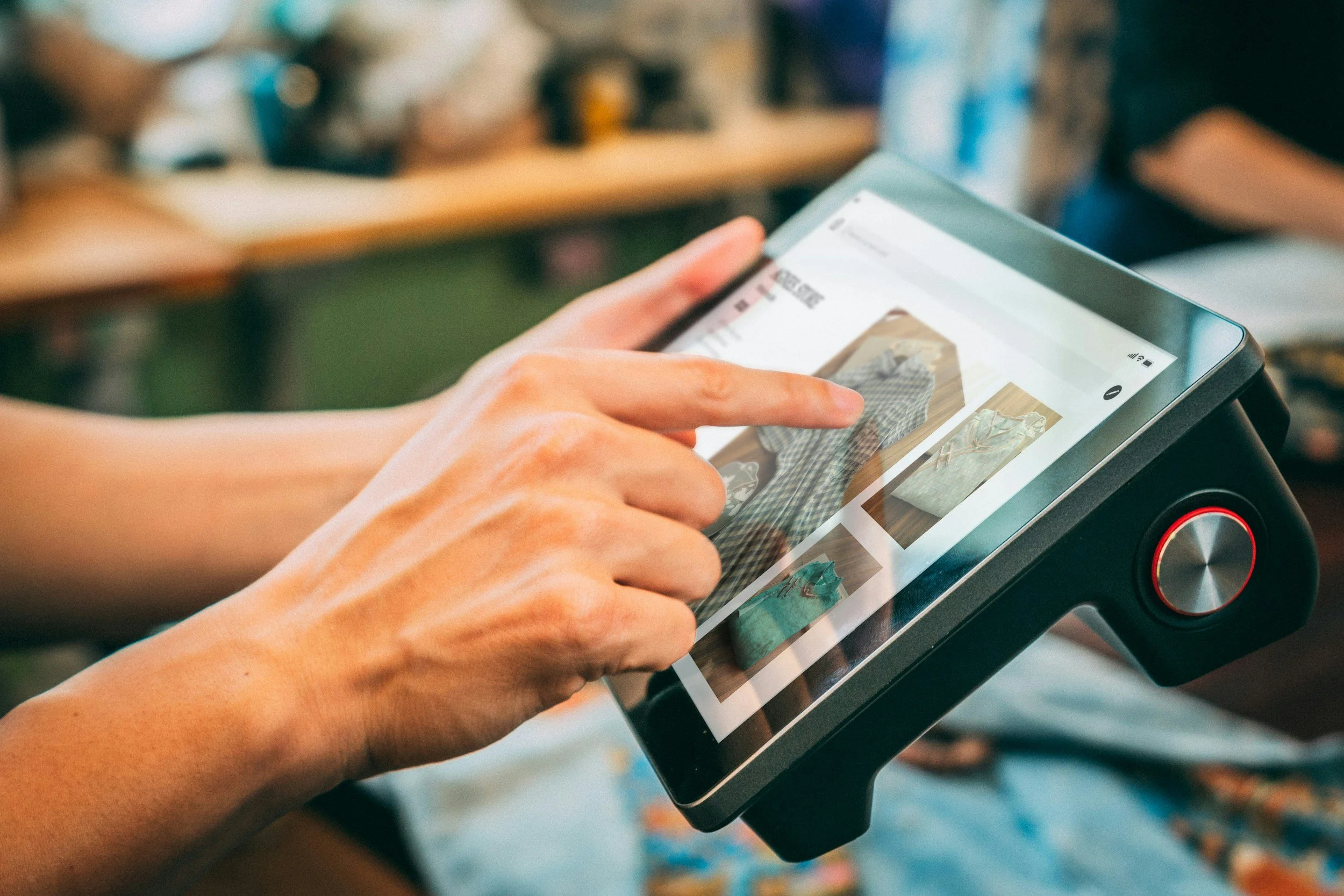 Person using a tablet device to browse furniture online.