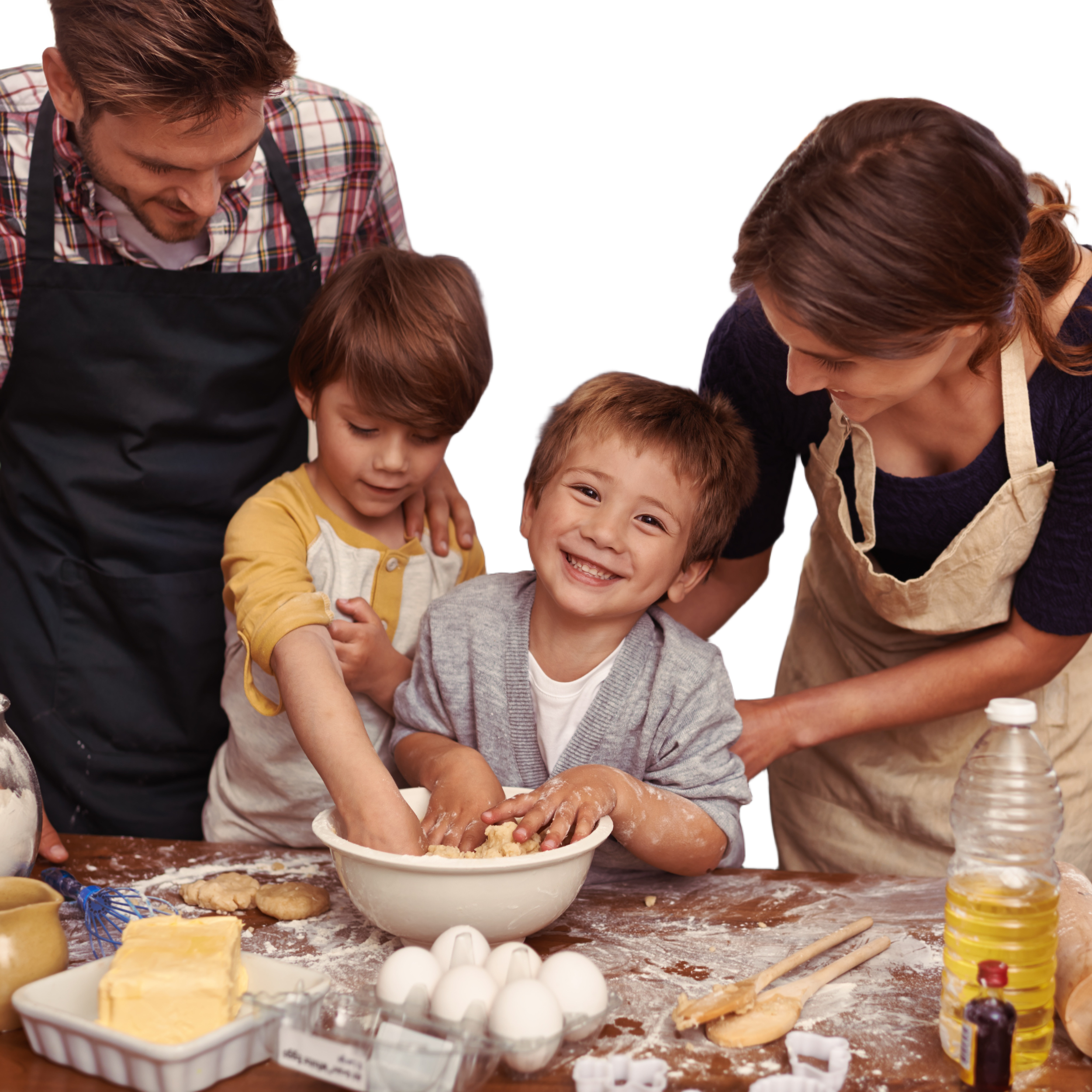 Two adults and two children baking together in a kitchen, with baking ingredients and utensils on the table.