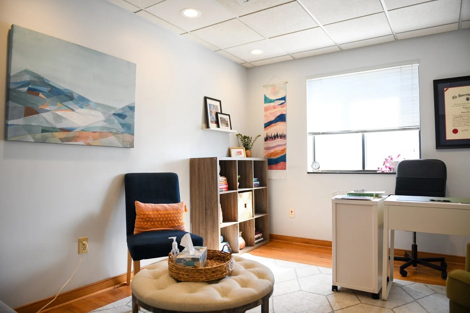 Interior room at Watermark's office located in Norfolk, VA. The room features a chair, desk, and ottoman with tissues.