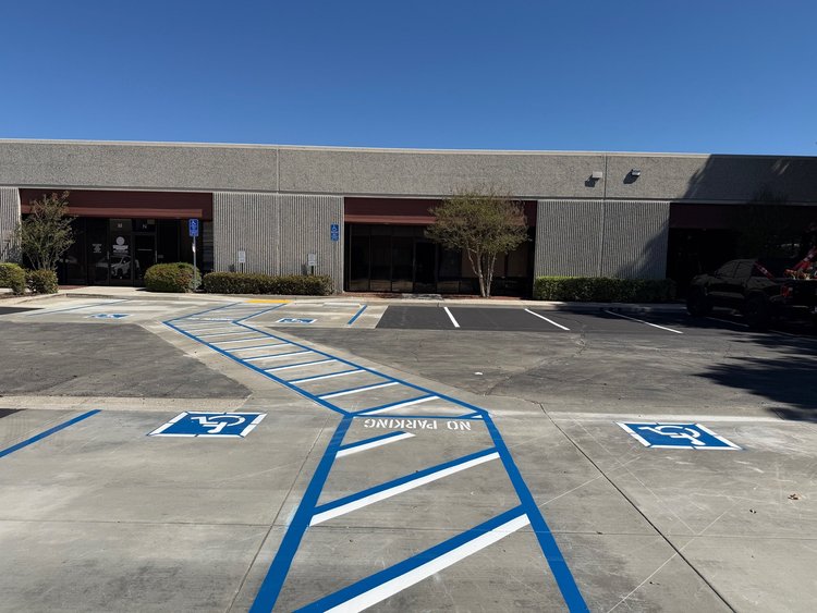 Path of travel striping across the parking lot