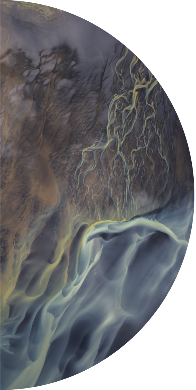 Satellite view of a river flowing through a mountainous landscape with visible tributaries.