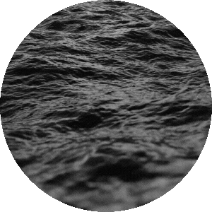Close-up of dark, rippling water in a circular frame.