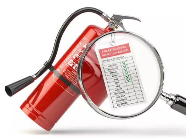 A fire extinguisher with a magnifying glass showing a record of inspections from January to December.