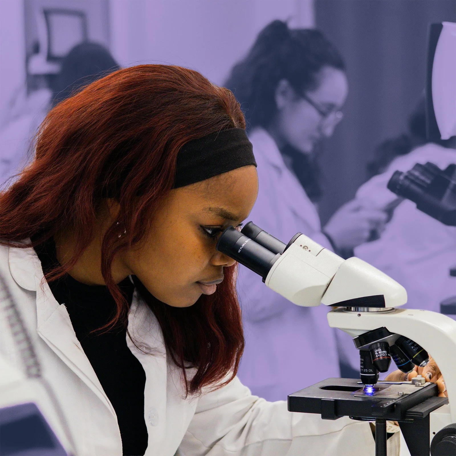 A biogist studies samples through a microscope