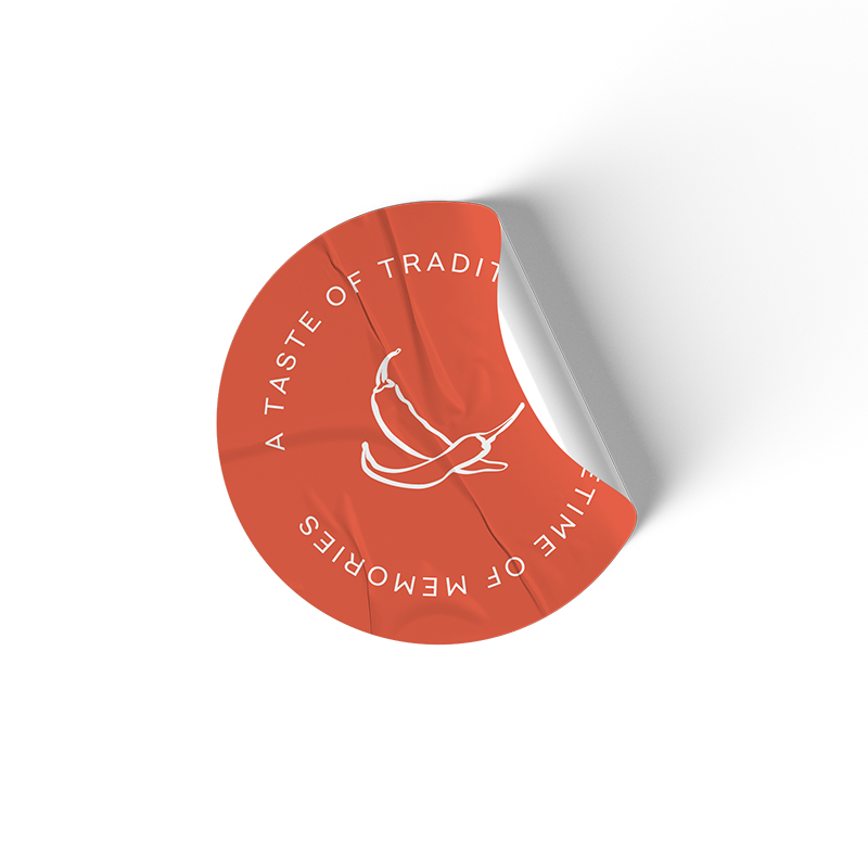 A circular sticker featuring a chili pepper illustration and the text 'A TASTE OF TRADITION' encircling the pepper on an orange background.