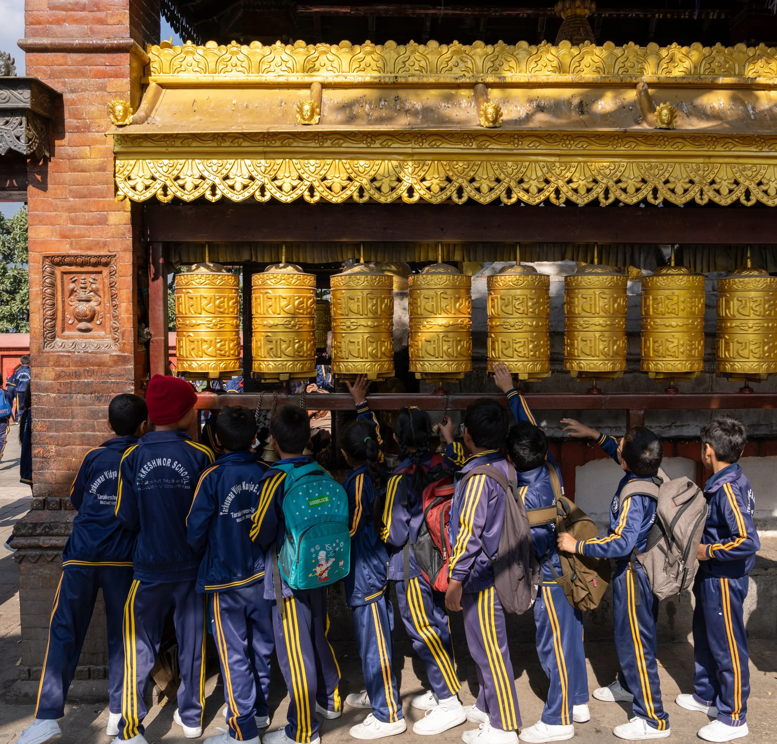 A class spins prayers wheels in Kathmandu