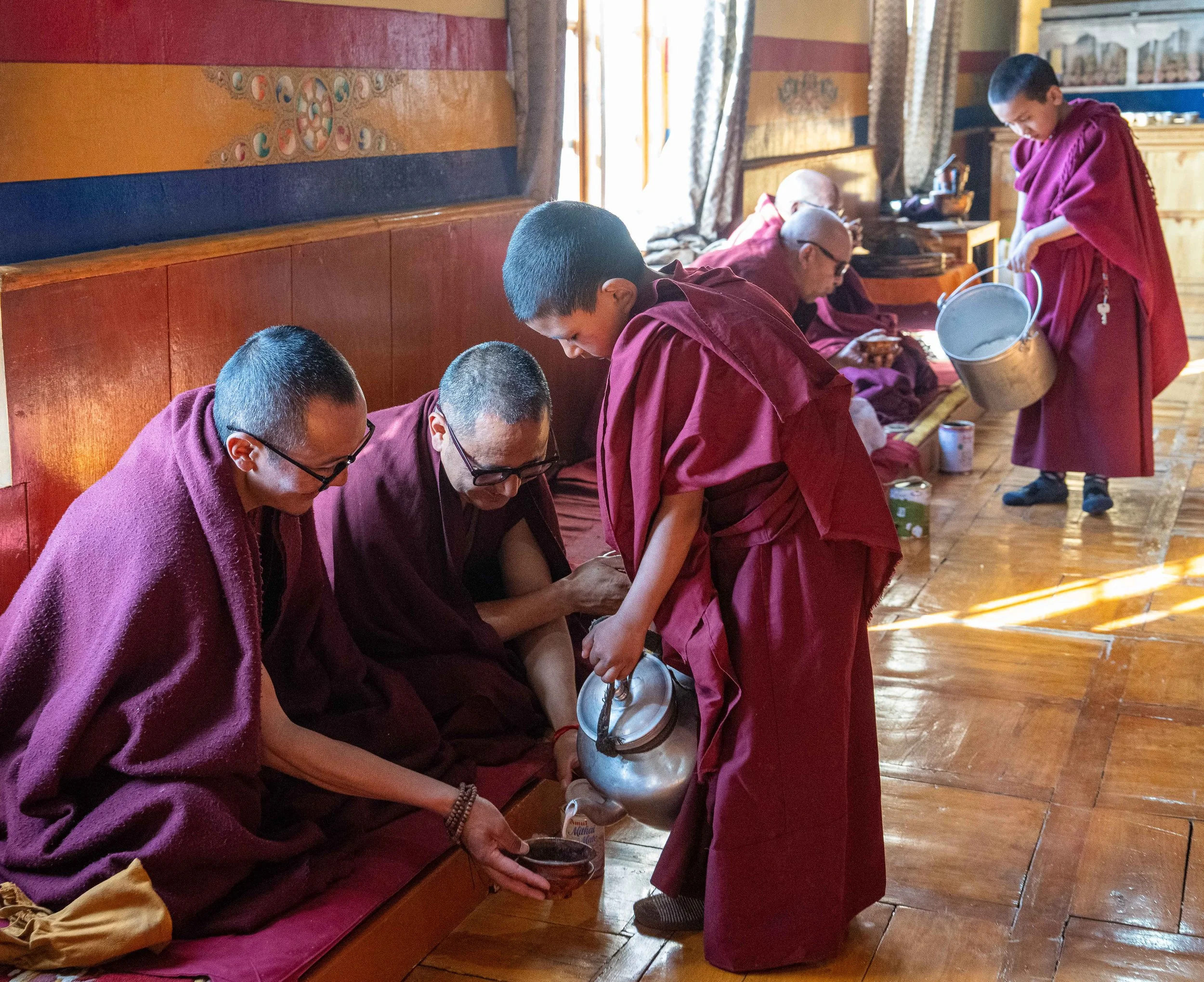 Buddhist monks enjoy morning tea at the Thisky Monastery in India