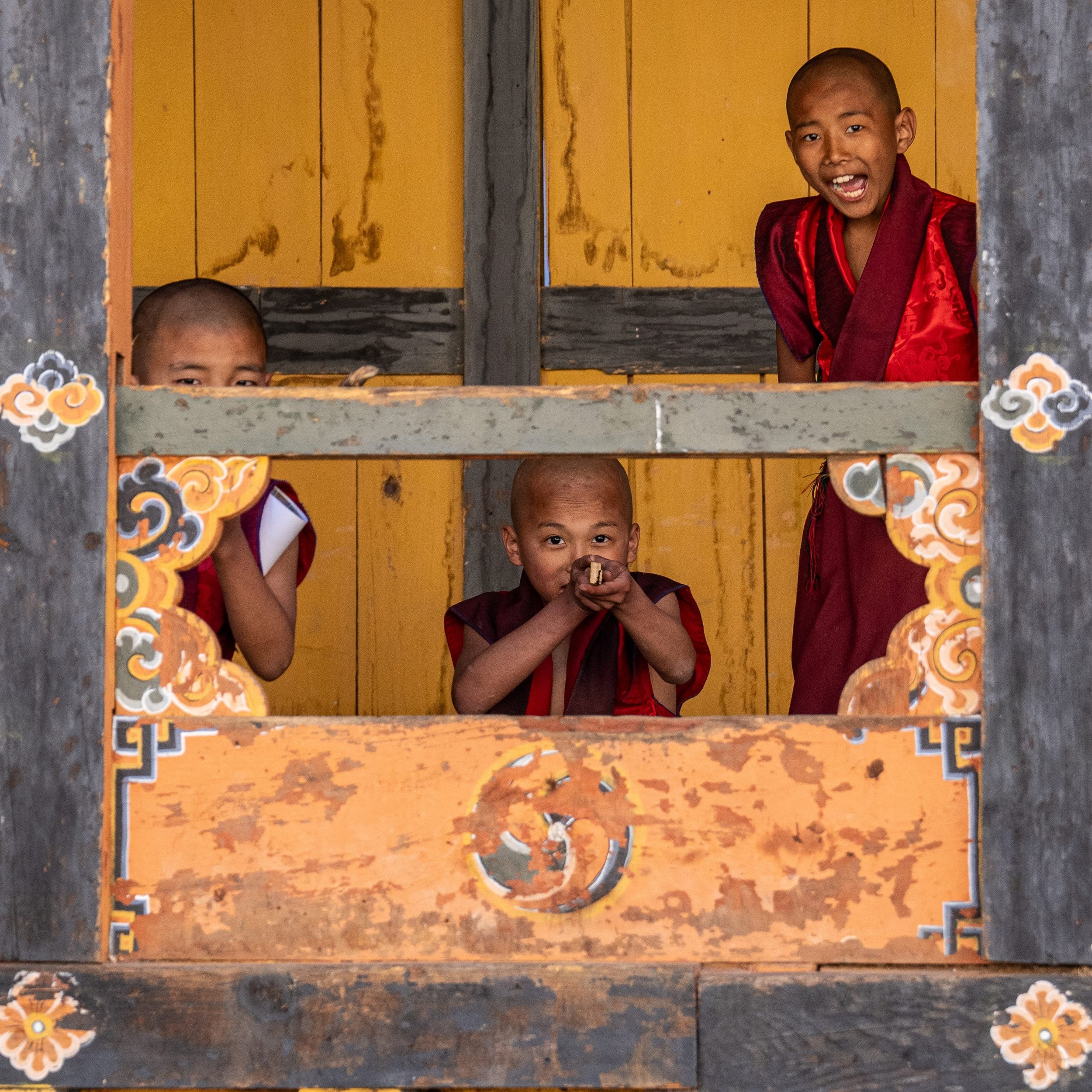 Young monks play fort in a literal Sixteenth Century Fort (Dzong) in Bhutan