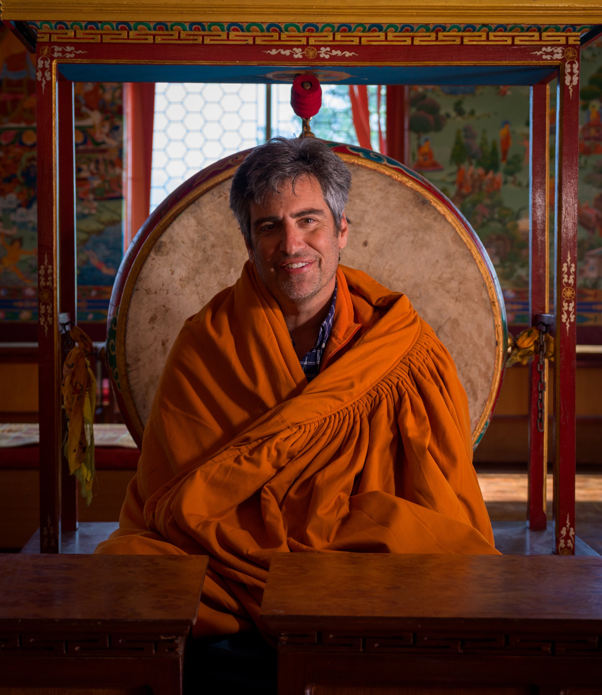 Paul Berger seated with a warm monk robe at the Pema Ts'al Monastery in Pokhara, Nepal