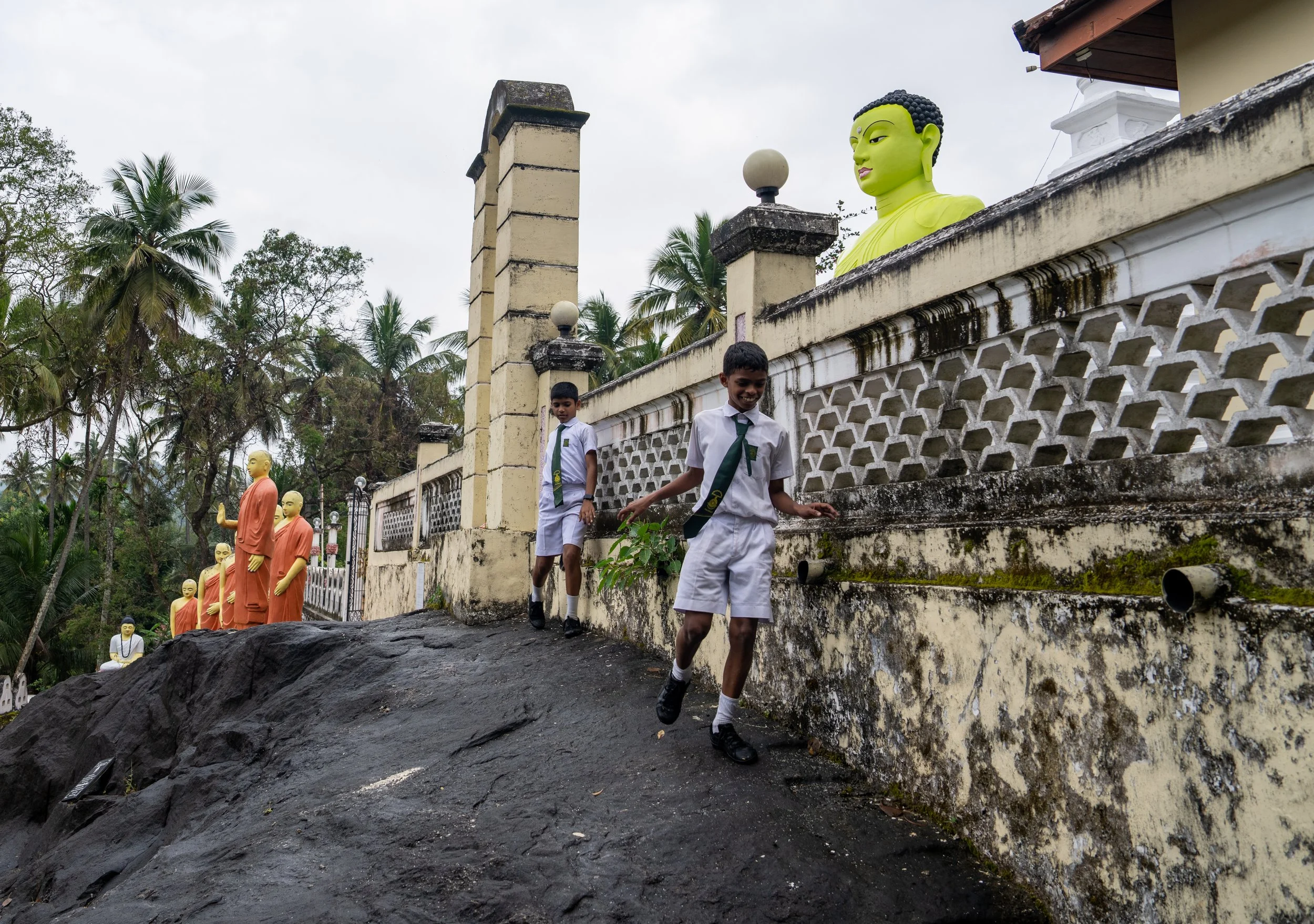 Young children play at the foot of a monastery in Sri Lanka