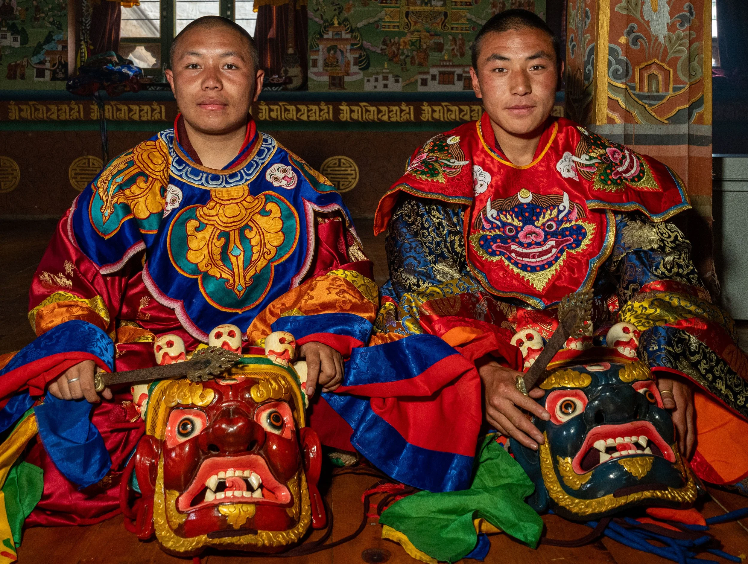Monks rest after performing Cham dance in Bhutan