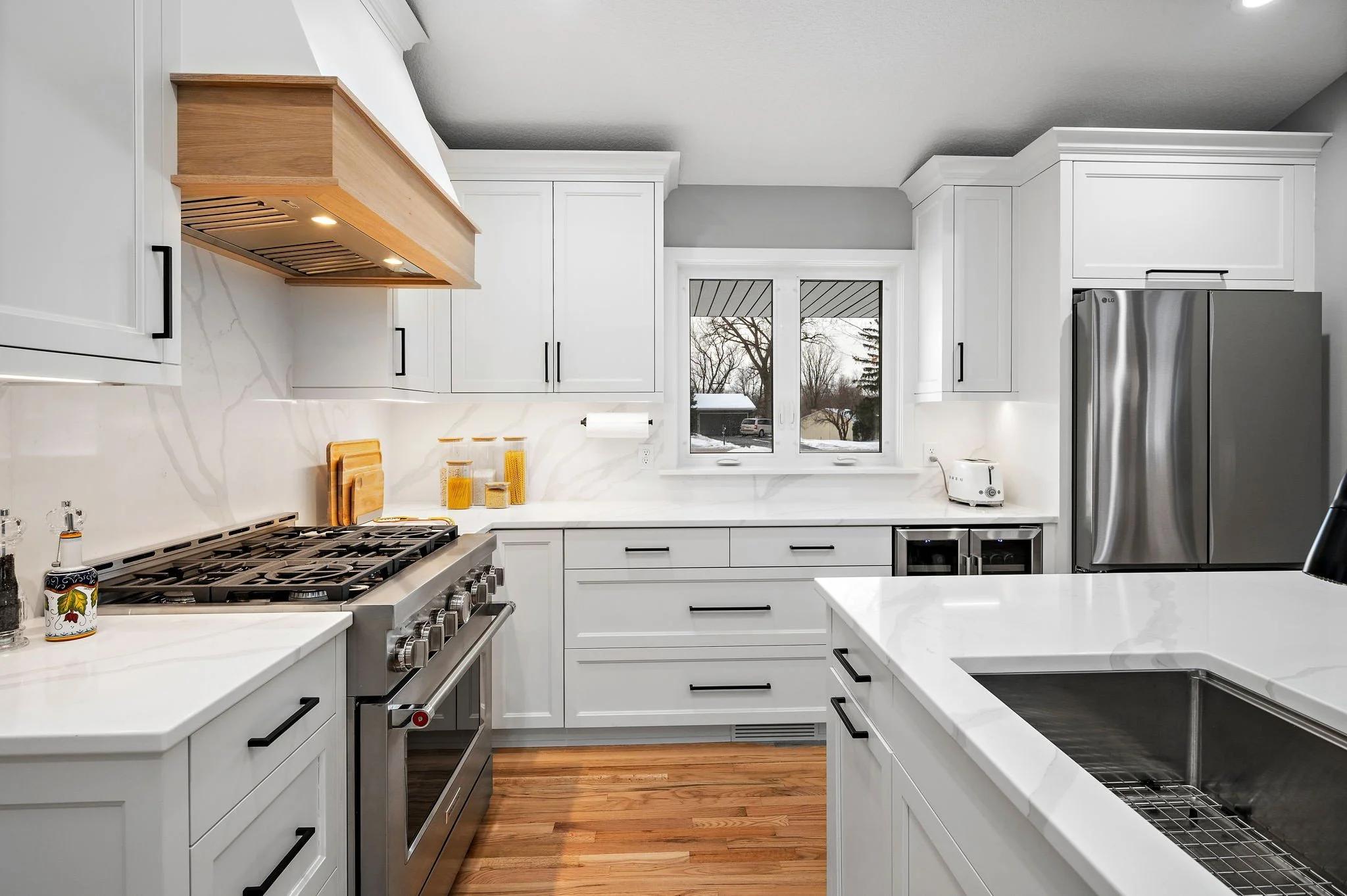 white shaker kitchen remodel with quartz island and custom wood range hood, Minnetonka