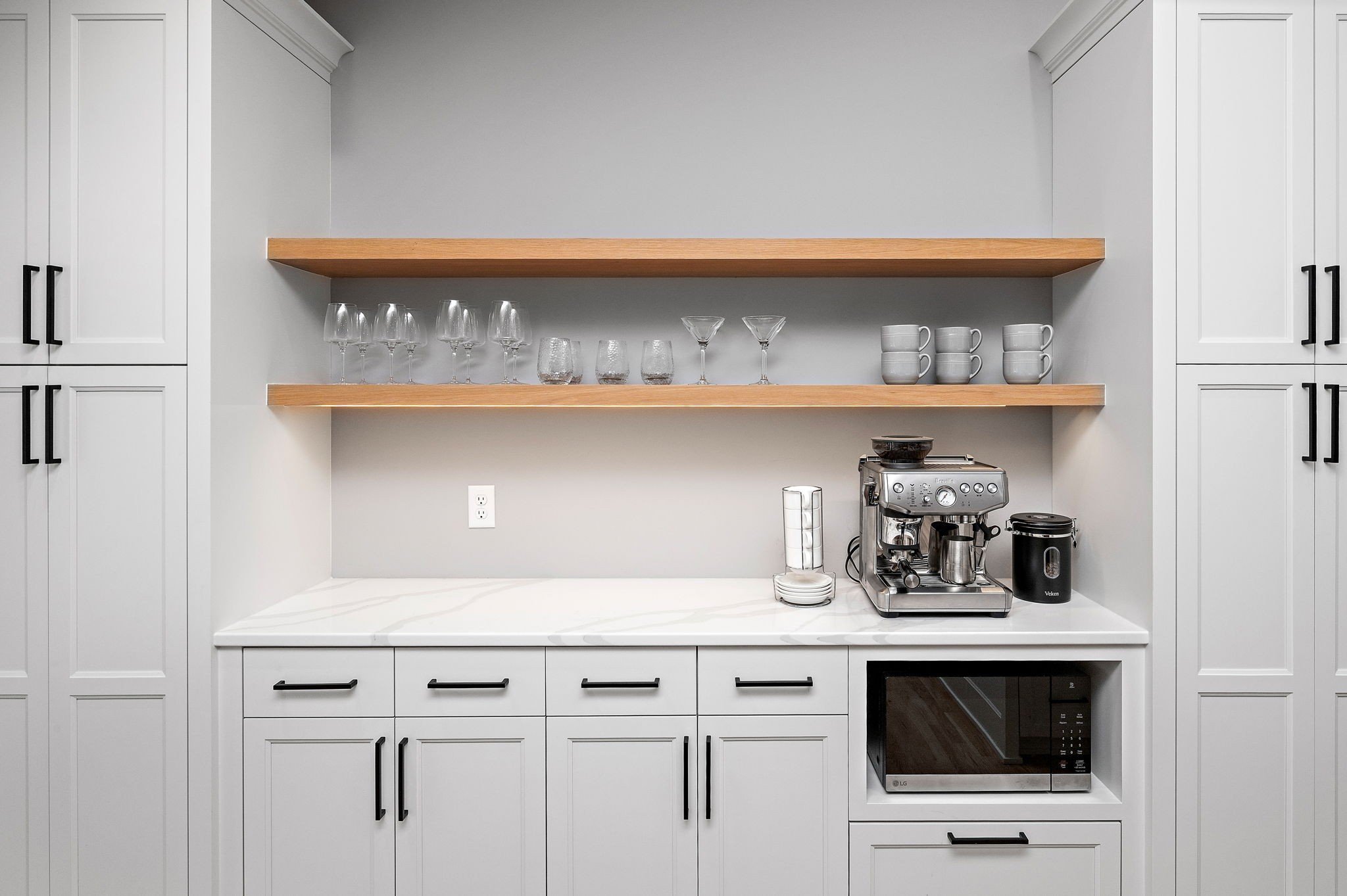 Custom coffee bar with white oak shelving
and built-in espresso station, Minnetonka
