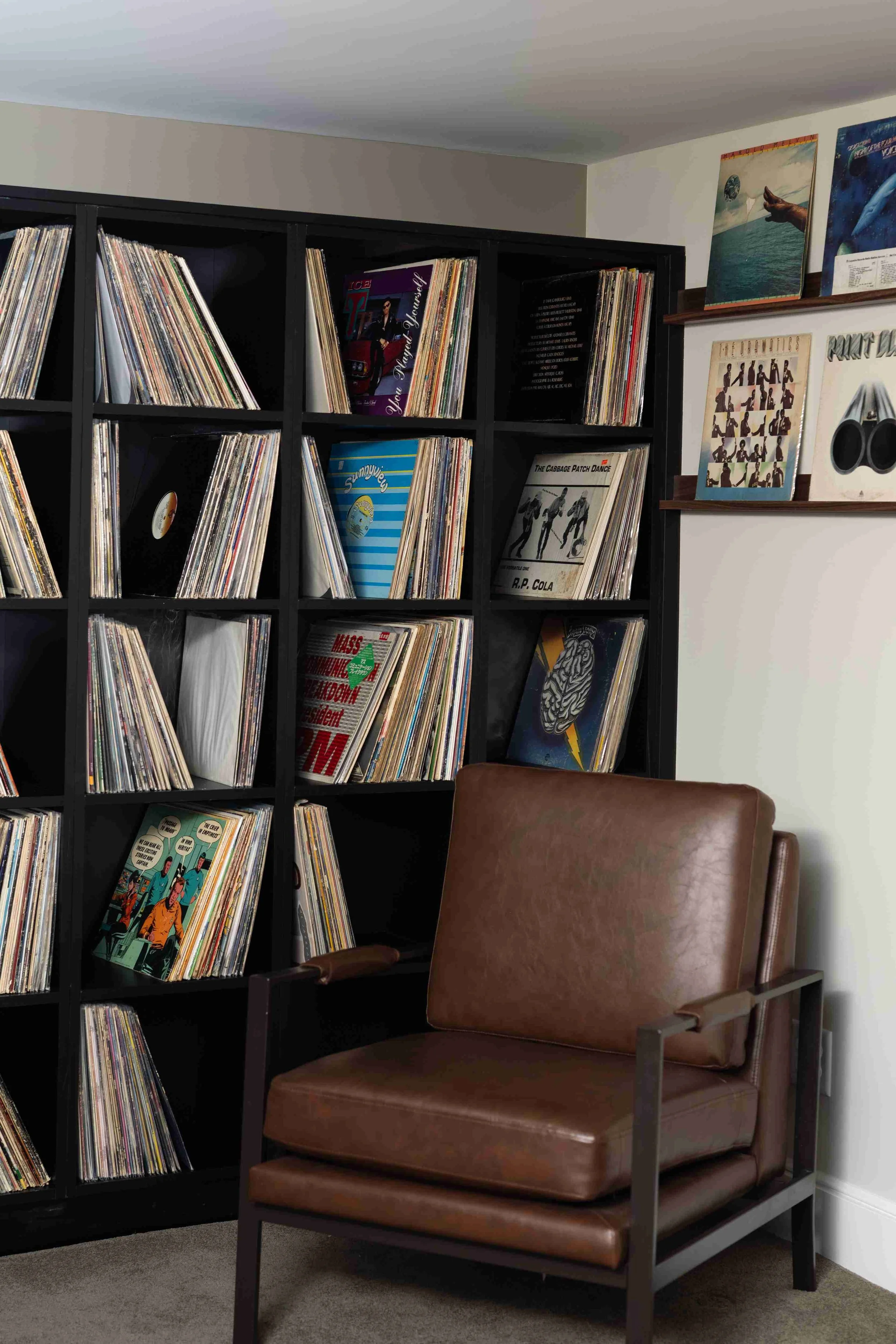 Built-in record storage cubbies and leather armchair, Minneapolis basement remodel