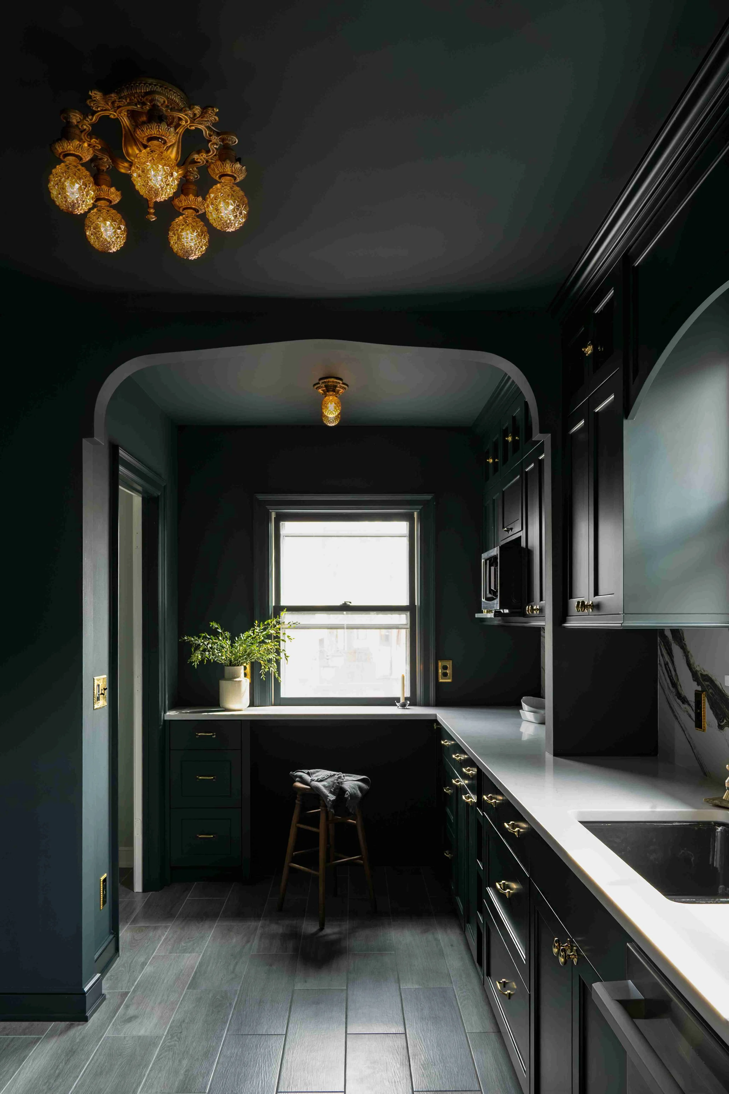 Custom corner cabinetry and built-in seating
nook, dark green shaker kitchen, Minneapolis