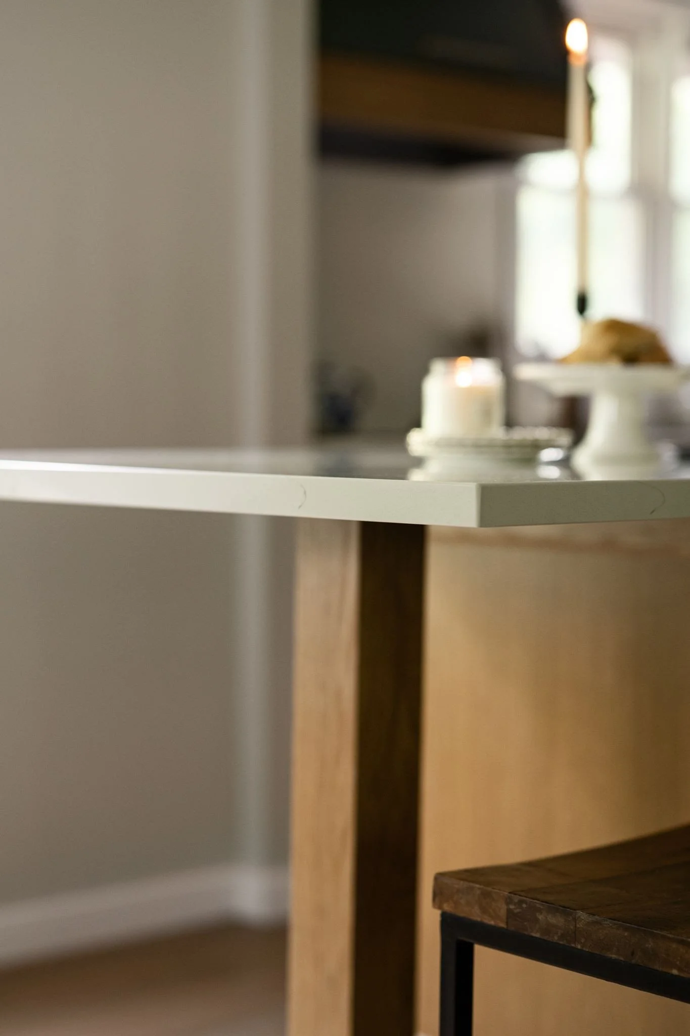 White quartz countertop edge on solid wood
post base, custom kitchen island Eden Prairie