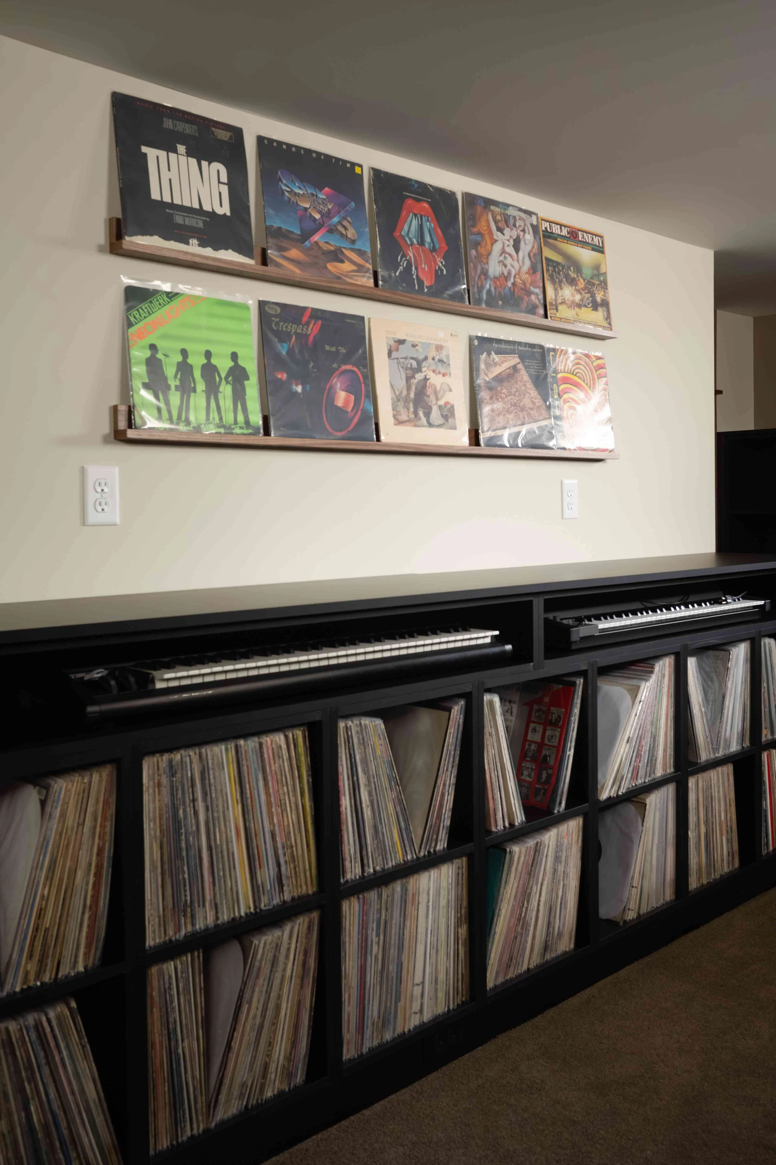 Album art display above custom built-in shelving, Minneapolis basement remodel
