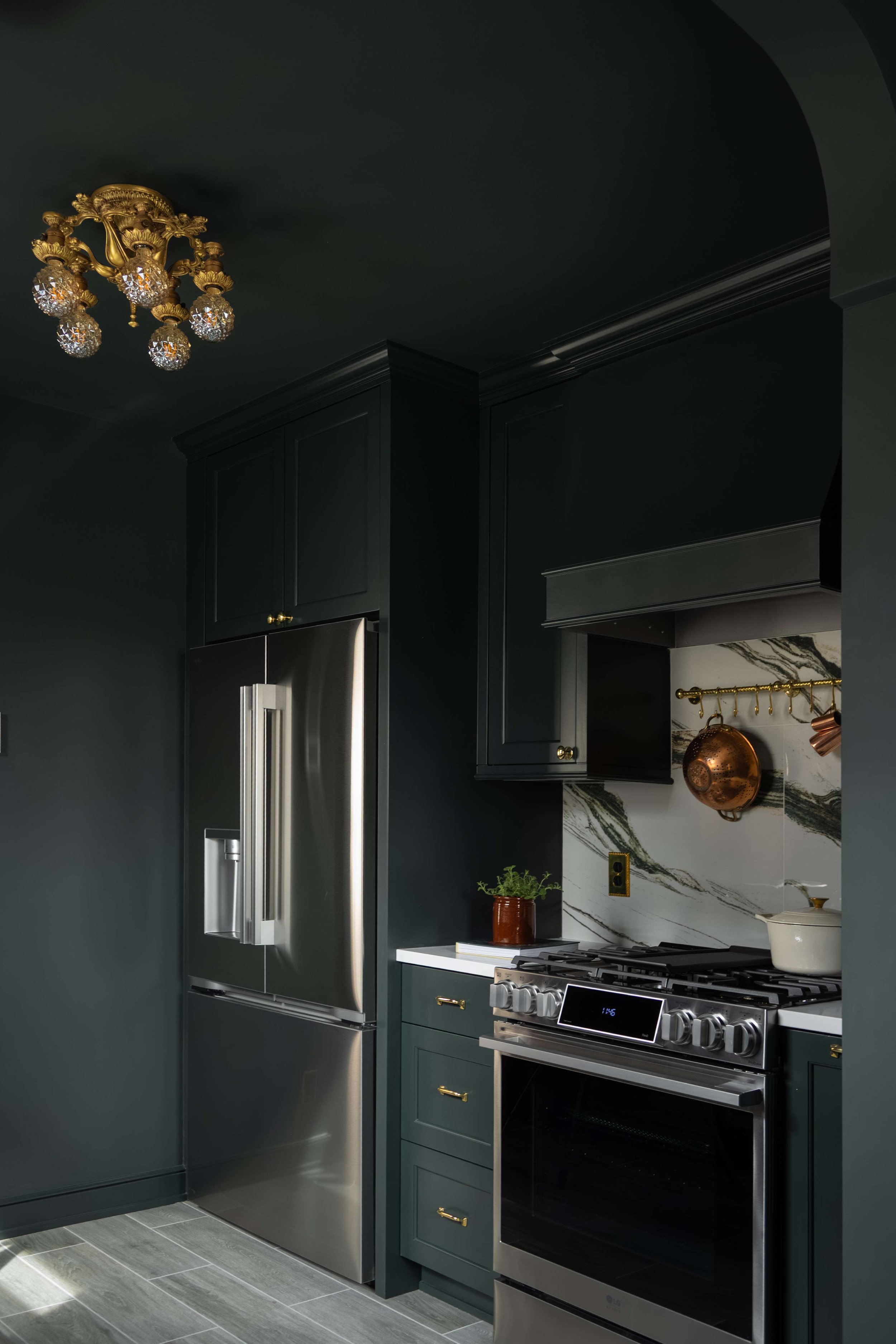 Gas range and panel-front refrigerator, dark
green cabinetry, Minneapolis kitchen remodel