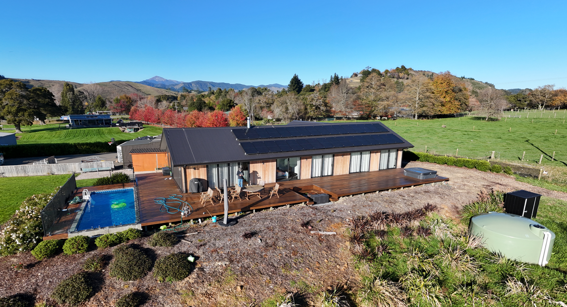 A modern house with solar panels on the roof installed by Rowan Dron Electrical