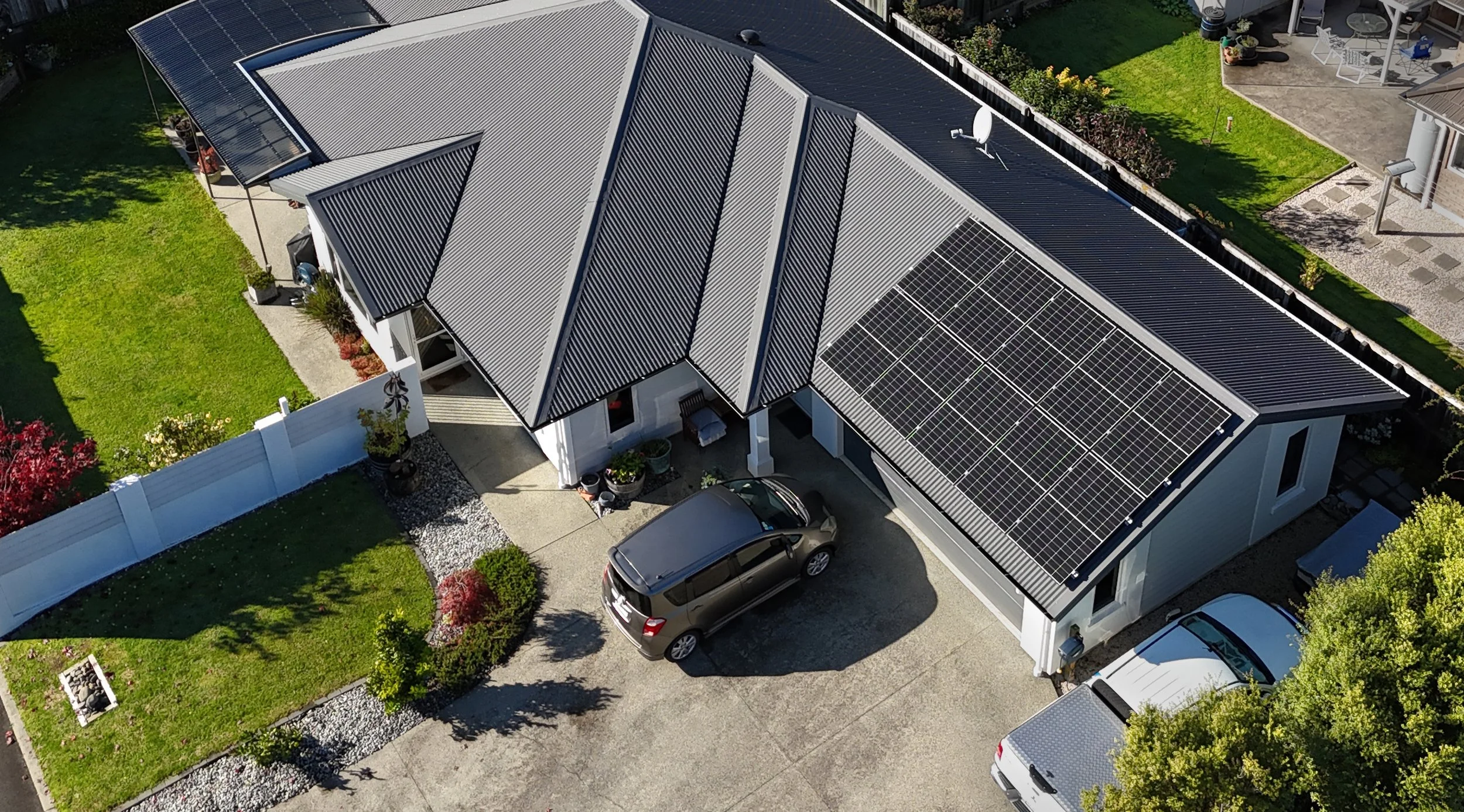 Aerial view of a house with solar panels on the roof installed by Rowan Dron Electrical
