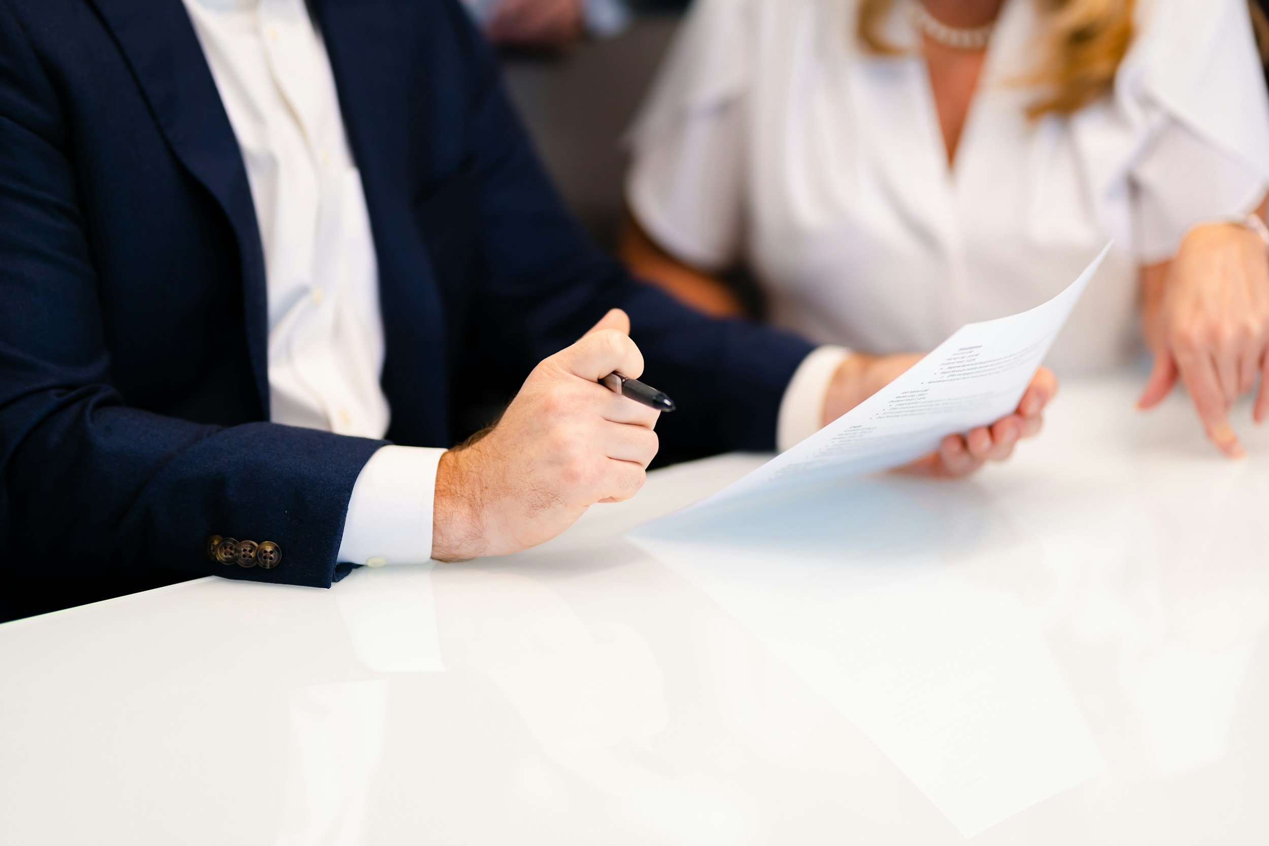 man looking at printed document with pen in his hand brisbane litigation lawyers