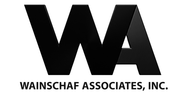 Black background with the logo and text for Wainschaf Associates, Inc., featuring stylized initials 'WA' in a three-dimensional black design.