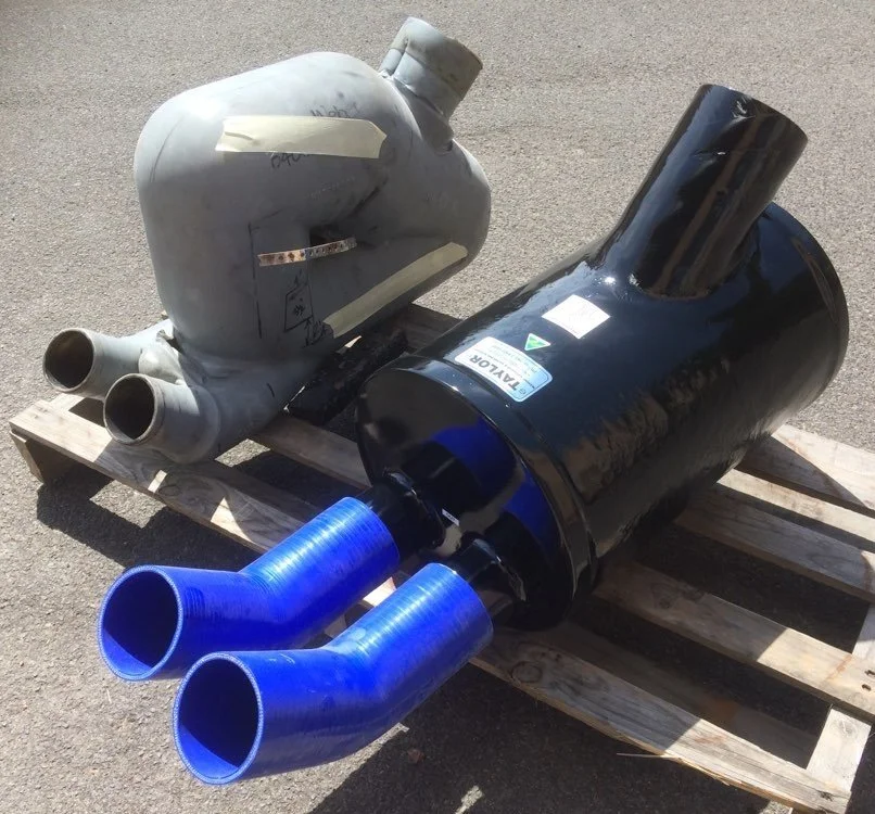 Custom wet exhaust assembly incorporating marine-grade silicone hose connections.