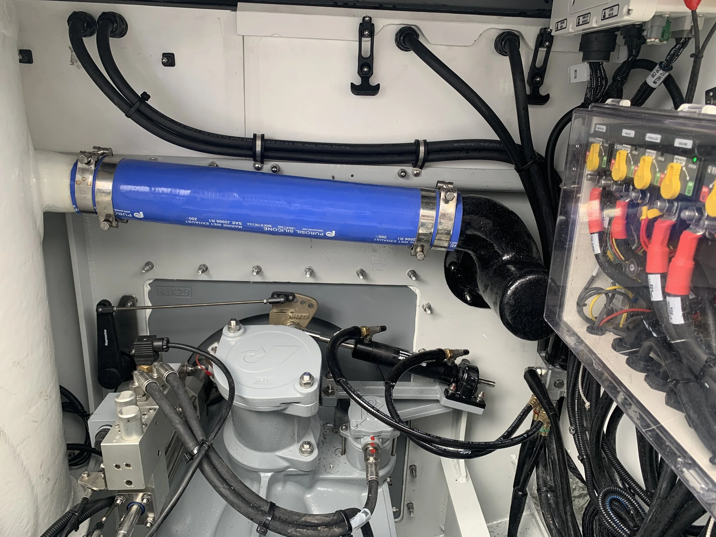 Completed custom wet exhaust installation incorporating Taylor Marine Exhaust mufflers, exhaust hose and vessel-specific pipework.