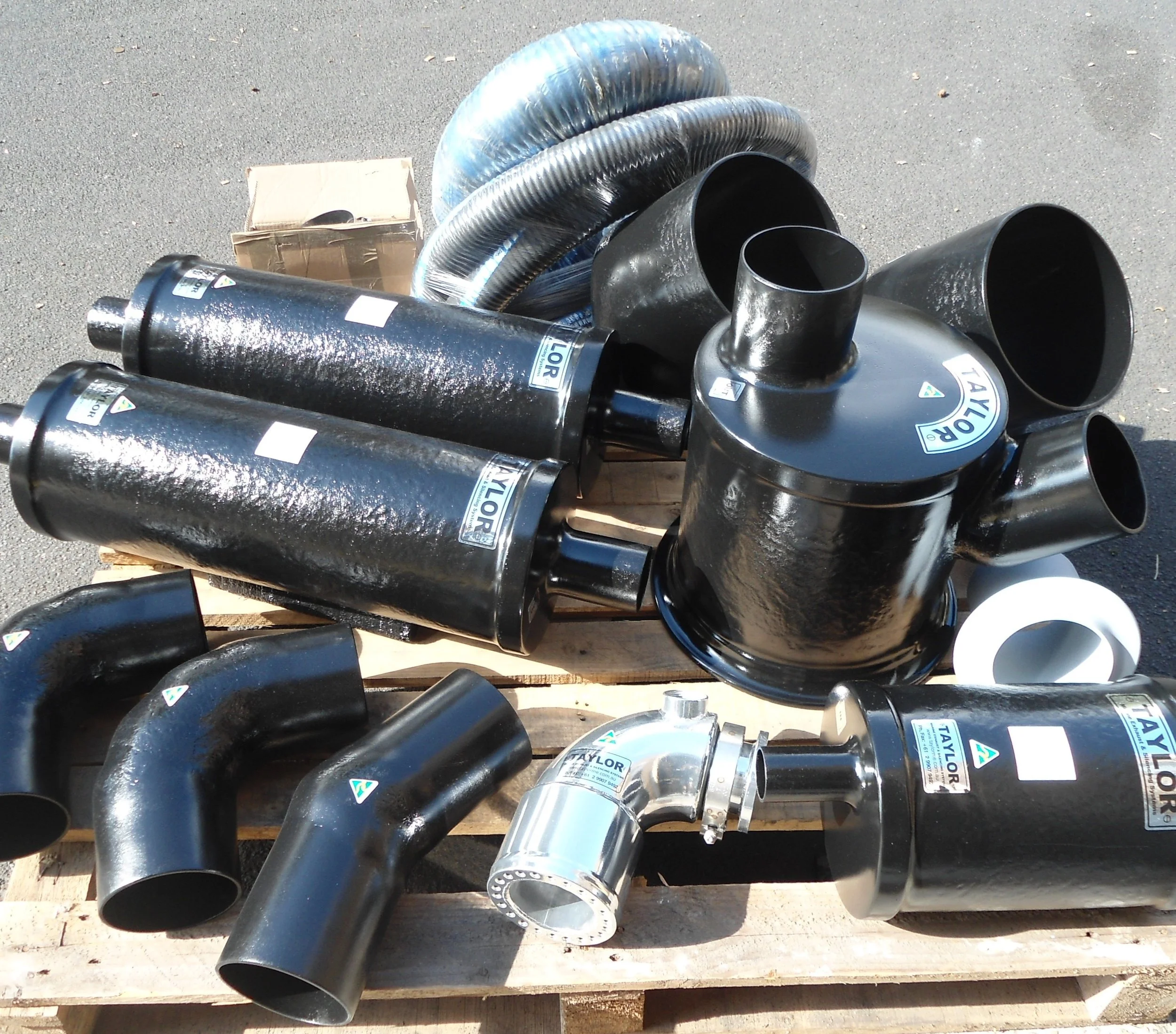 Custom wet exhaust package comprising vinyl ester water lift mufflers, silencers, bends and stainless steel exhaust components manufactured for a vessel-specific installation.