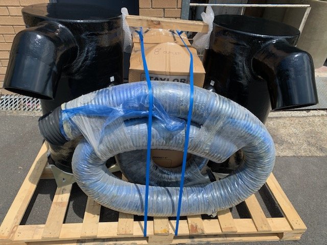 Custom exhaust installation incorporating vessel-specific hose routing and component selection to suit challenging installation requirements.