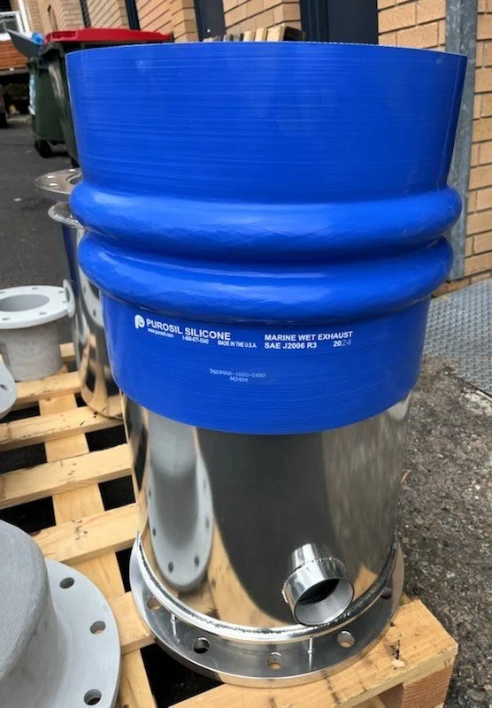 Marine-grade silicone exhaust hose connection for custom wet exhaust installations.