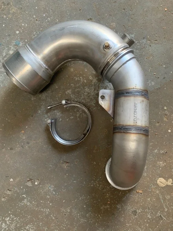 Custom fabricated stainless steel exhaust elbow assembly for marine applications.