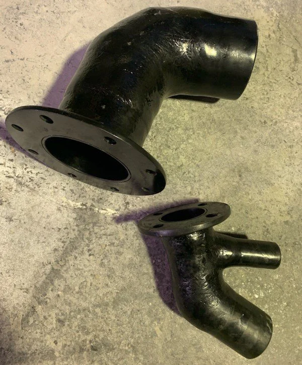 Flanged vinyl ester exhaust fittings manufactured for marine wet exhaust system installations.