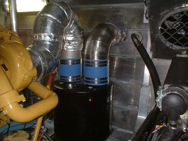 Custom insulated wet exhaust installation manufactured for a commercial vessel operating in a demanding marine environment.