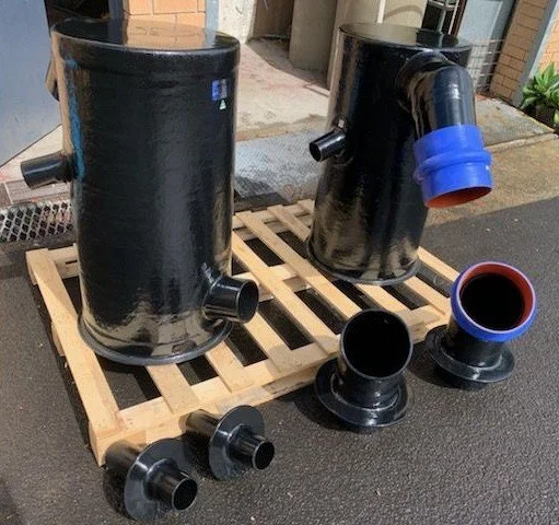 Custom vinyl ester components manufactured for a vessel-specific wet exhaust installation requiring a tailored system layout.