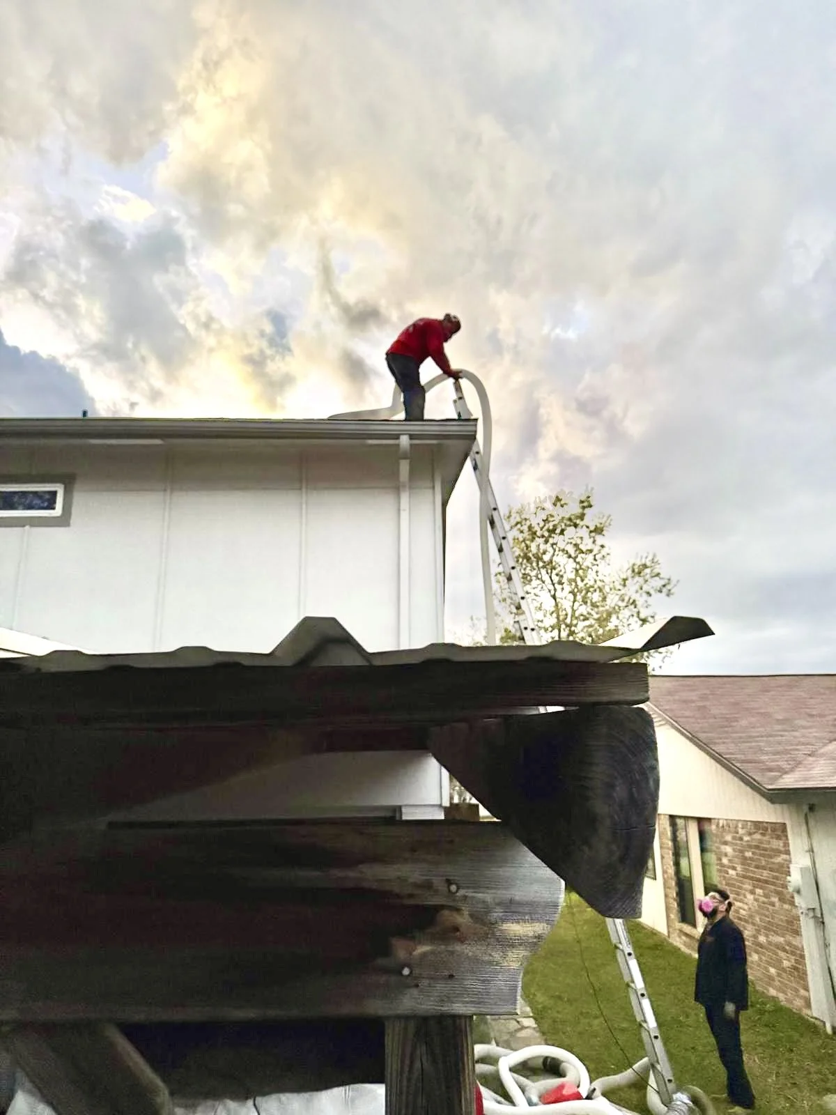 A insulation company packing up hoses from insulation removal job