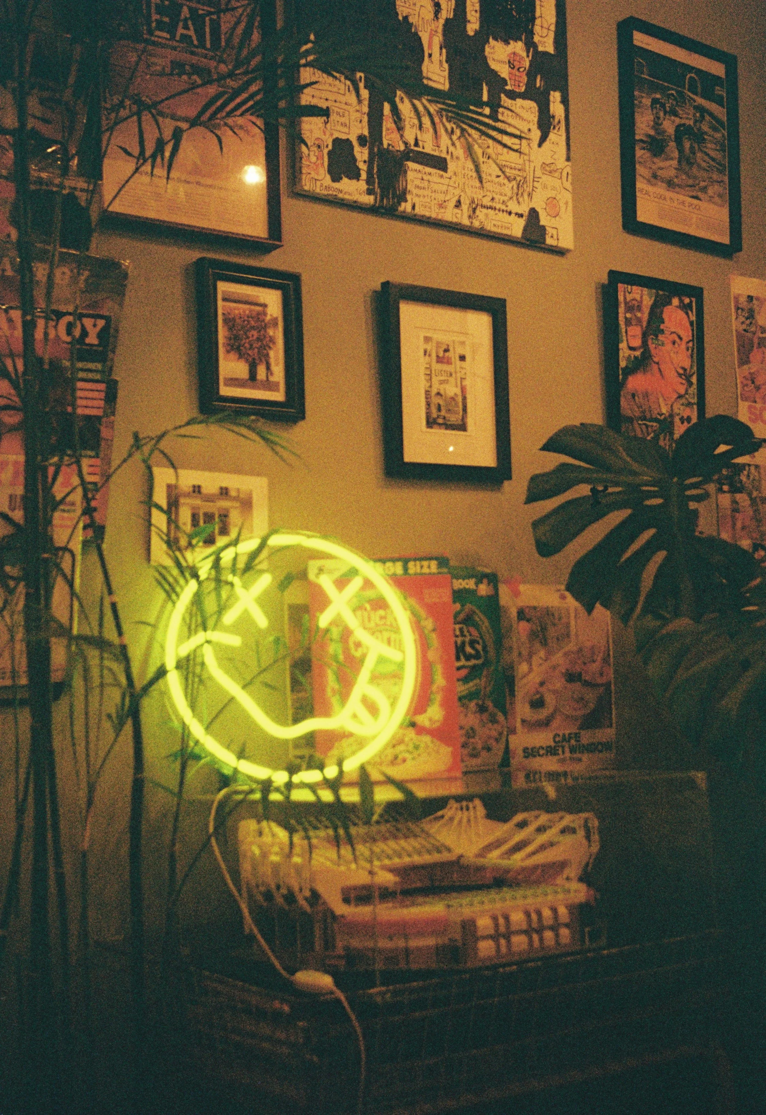 Neon smile light inside an artistic Japanese cafe photographed on analog film.