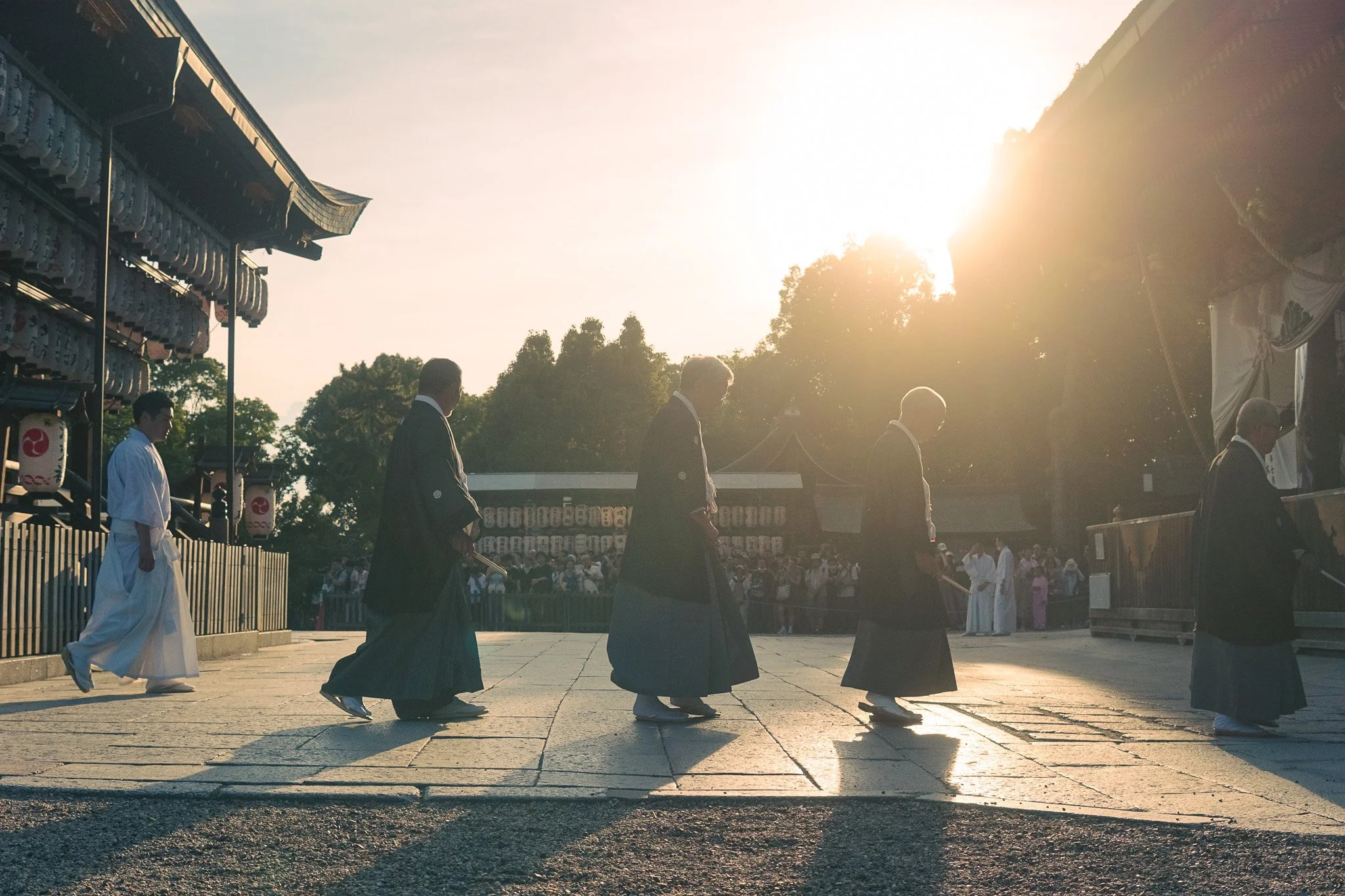 Traditional ceremony at Yasaka Shrine during sunset in Kyoto.