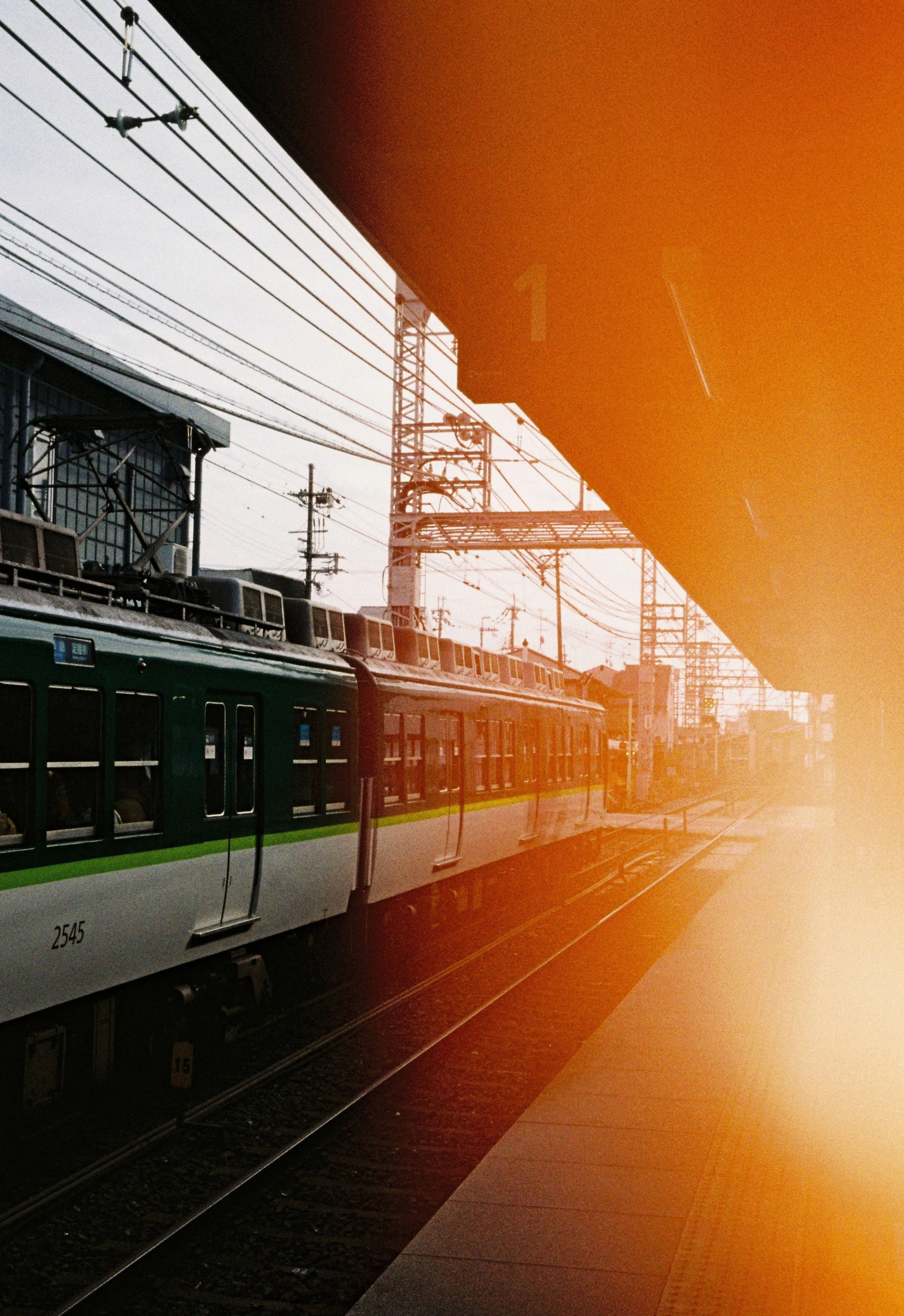 Japanese train arriving at a station during golden hour photographed on Kodak Gold 200.