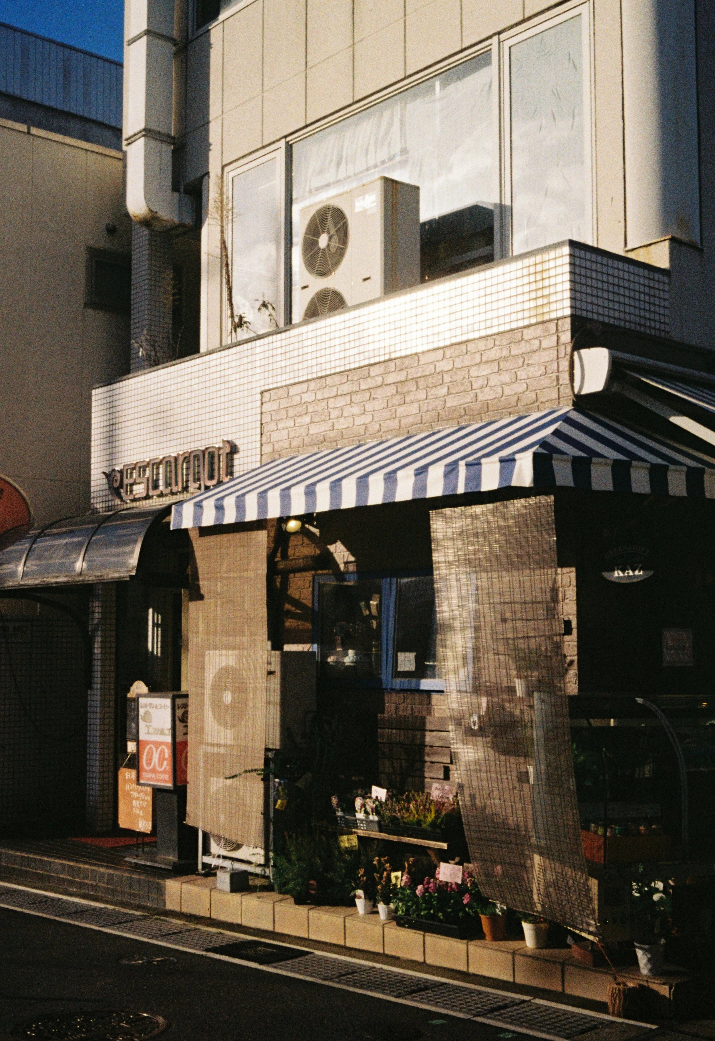 Quiet coffee shop street scene in Japan photographed on Kodak Gold 200 film.