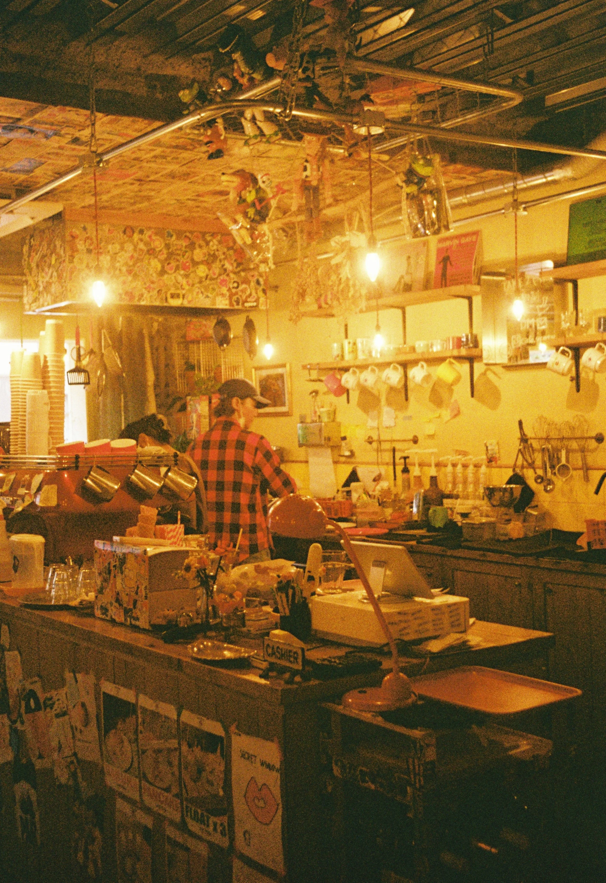 Warm and cozy cafe interior in Japan captured on Kodak Gold 200 film.
