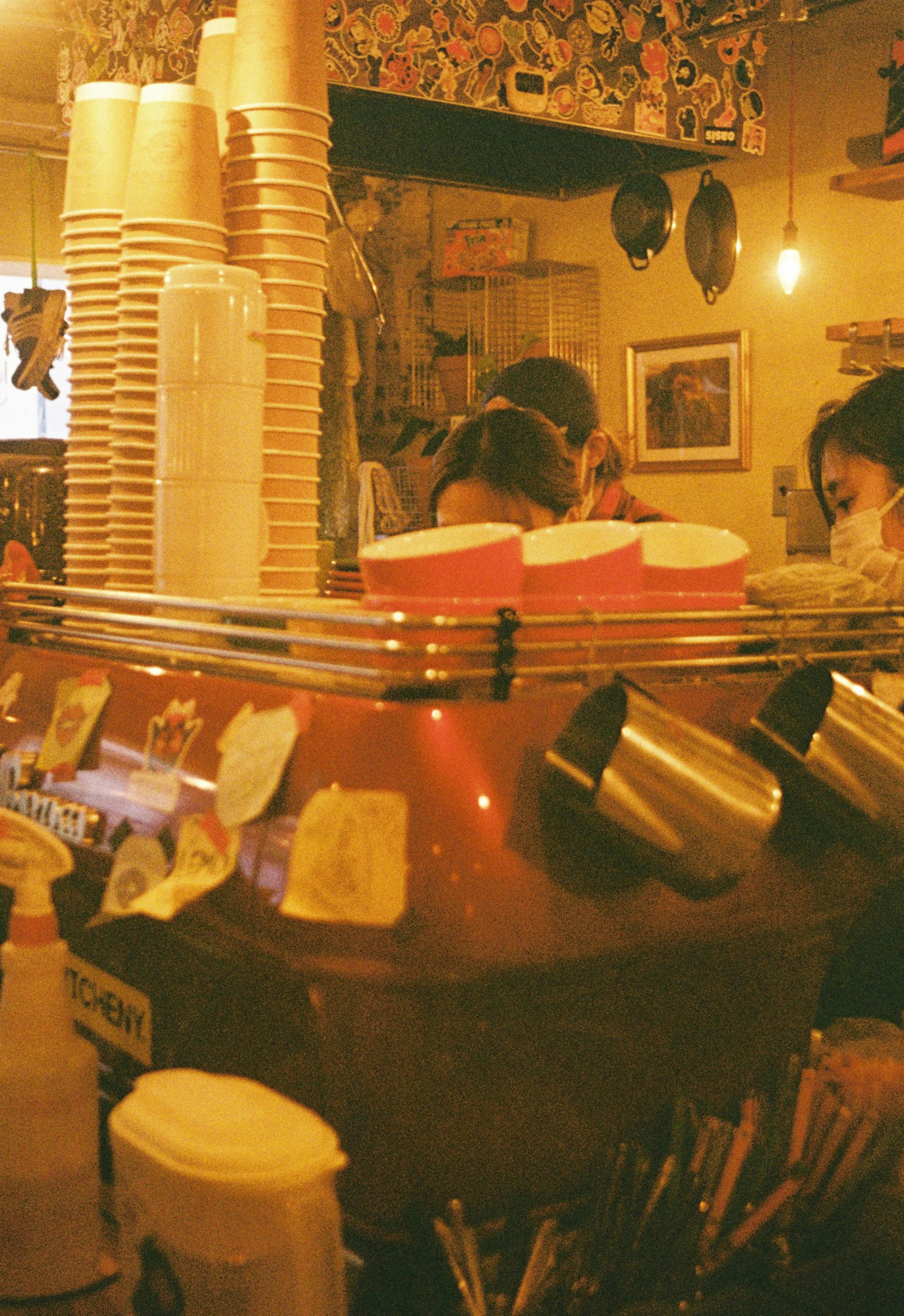 Warm cafe counter scene with cinematic lighting photographed on Kodak Gold 200.