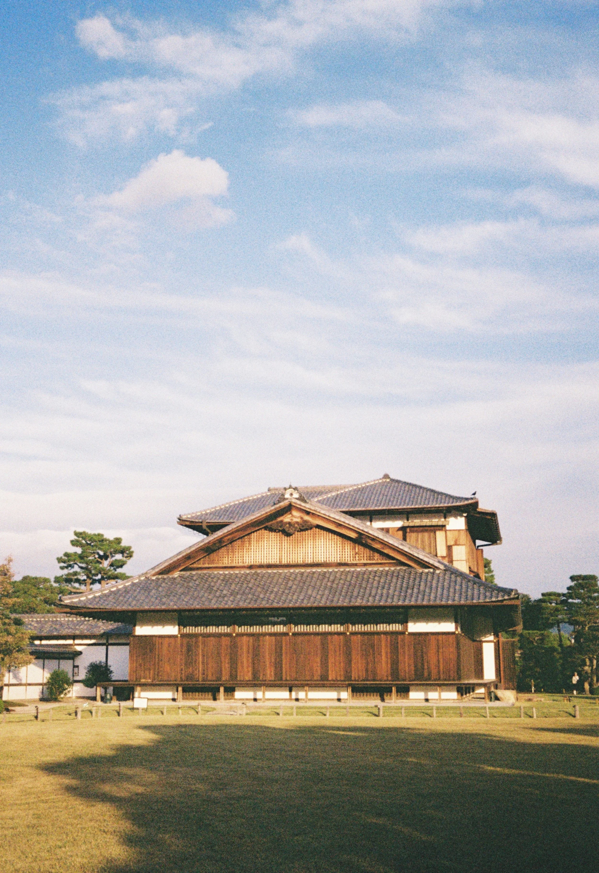Traditional Japanese wooden house under soft daylight photographed on film.