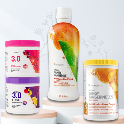 Three bottles of Youngevity Tangy Tangerine supplements, one with an orange design, one with a pink lid labeled 3.0, and one with a yellow lid labeled 2.5, on a white surface with a light background.