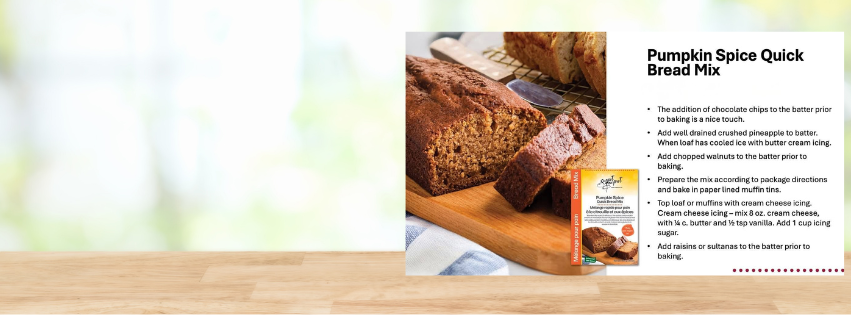 Box of Pumpkin Spice Quick Bread Mix beside a sliced loaf of bread on a wooden cutting board.
