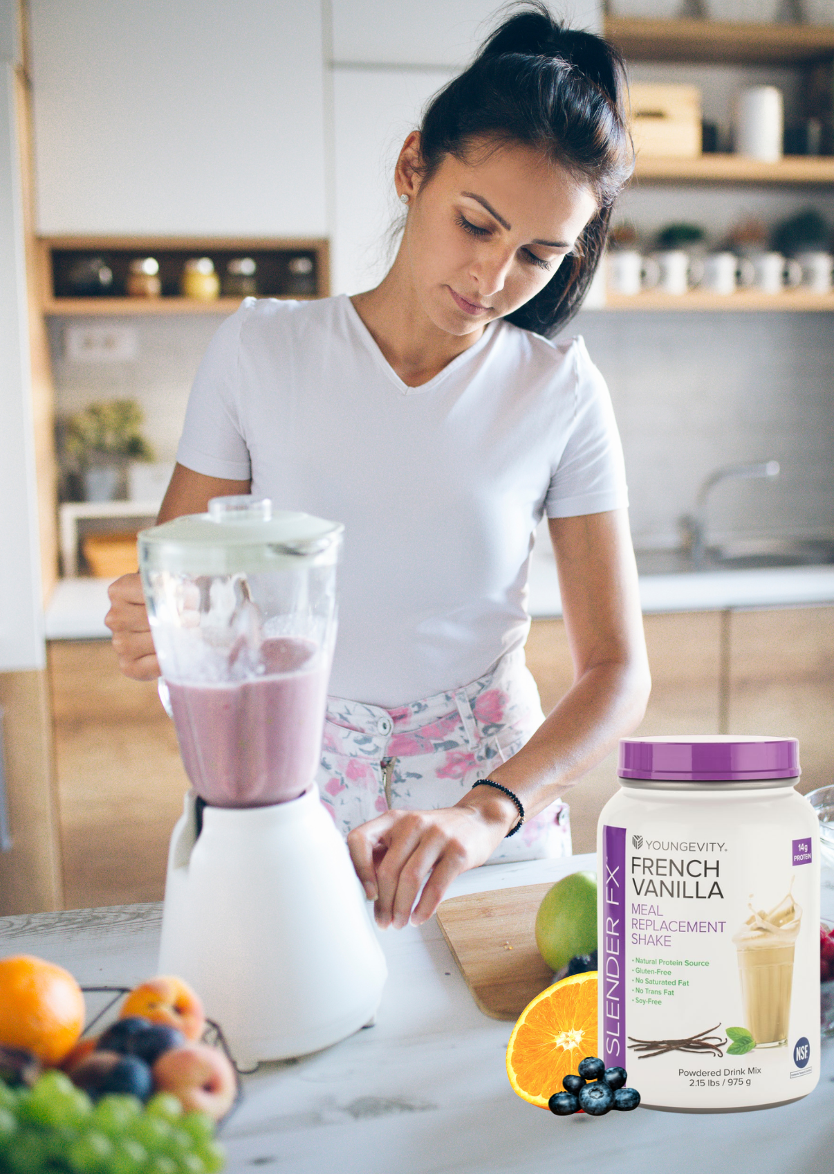 Woman in a white shirt making a smoothie in a kitchen with a blender, a container of SlimFast French Vanilla meal replacement shake, and fresh fruit on the countertop.