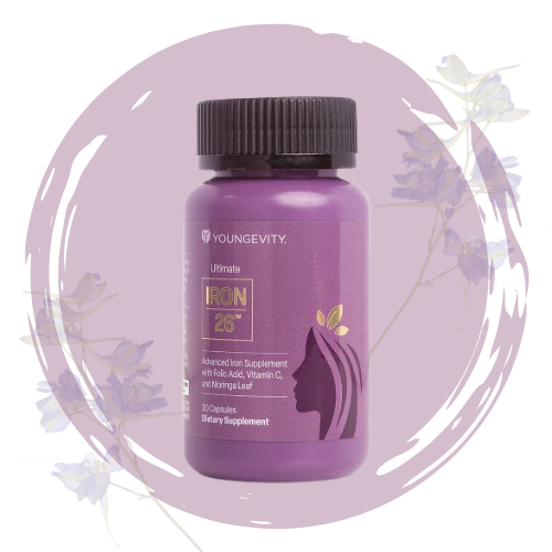 Bottle of Youngevity Ultimate Iron 26 dietary supplement with purple label and black cap, surrounded by purple and light purple flowers on a purple background.