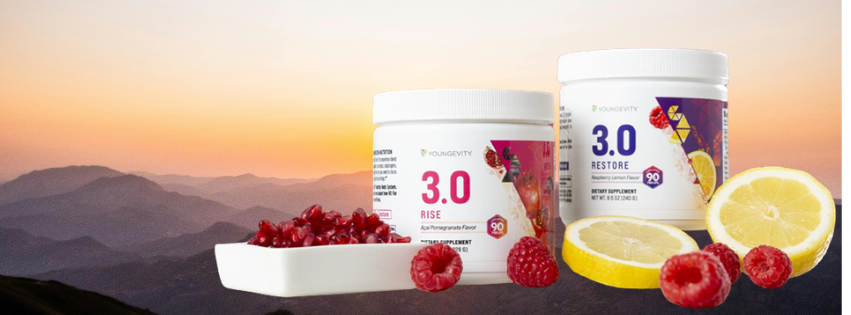 Two containers of YoungEVitv 3.0 Rise and 3.0 Restore supplements with lemon slices, raspberries, and pomegranate seeds on a white dish against a mountain sunset background.
