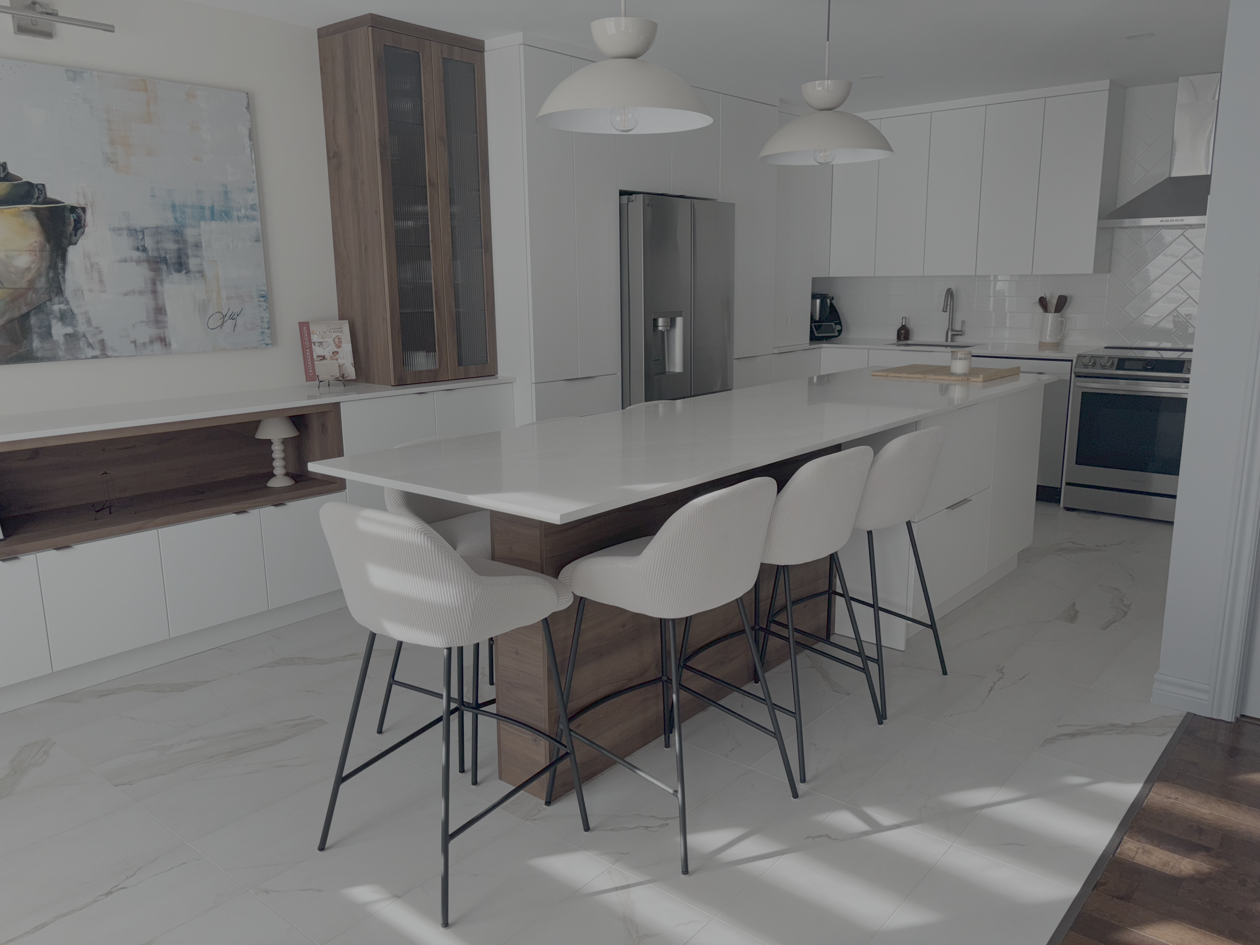 Modern kitchen renovated by Garcia Construction Rénovation in Quebec City, featuring white cabinetry, dark wood accents, a large peninsula and herringbone backsplash. 