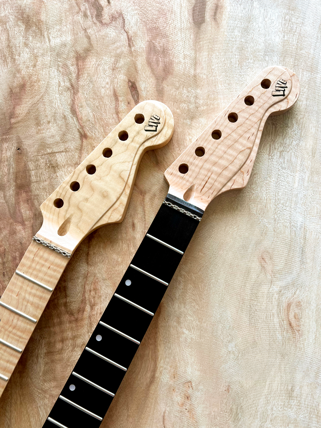 Guitar heads with the logo for Live Guitars